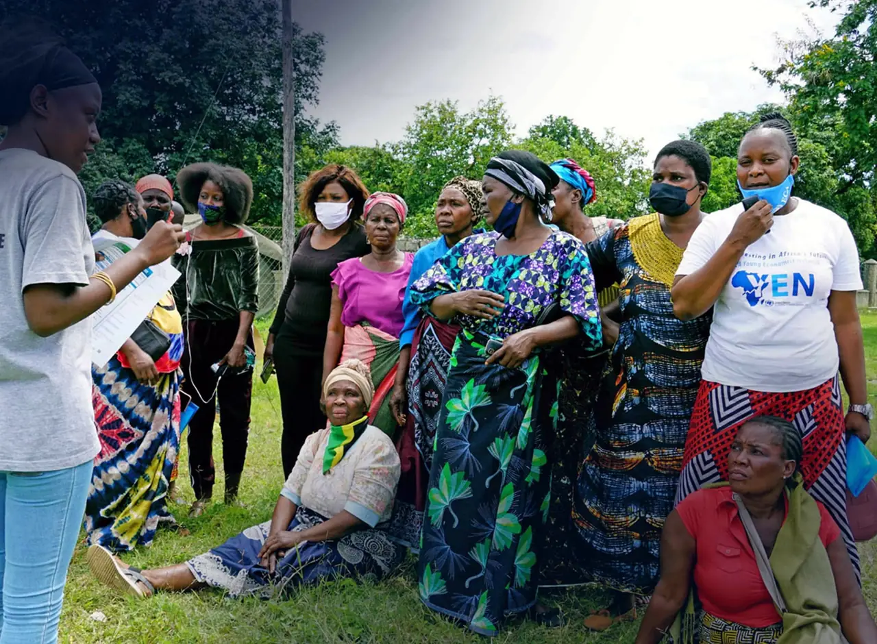 A field officer with a tablet standing among a group of women and men outdoors, confirming what was collected